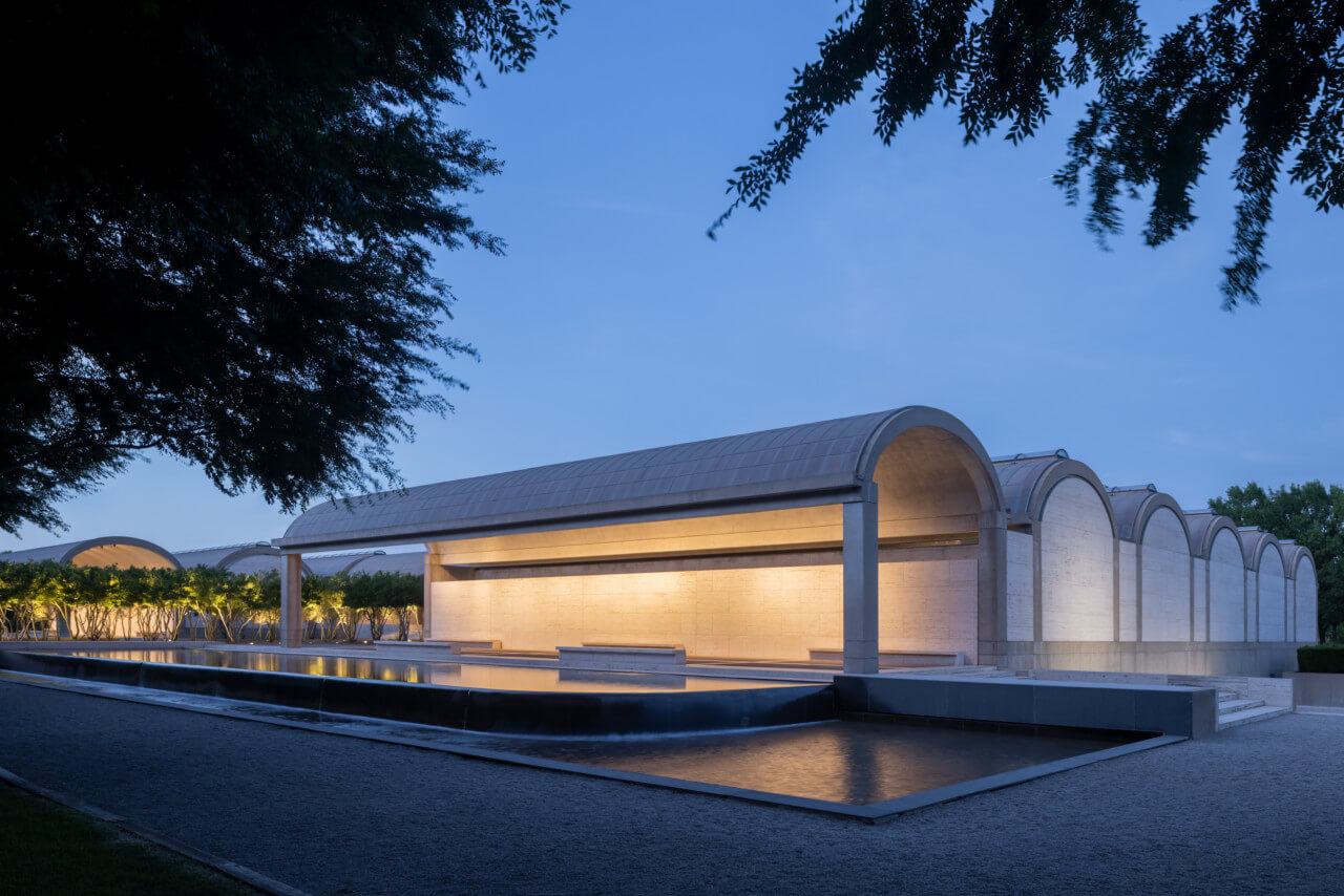 an art museum with a barrel-vaulted roof at night