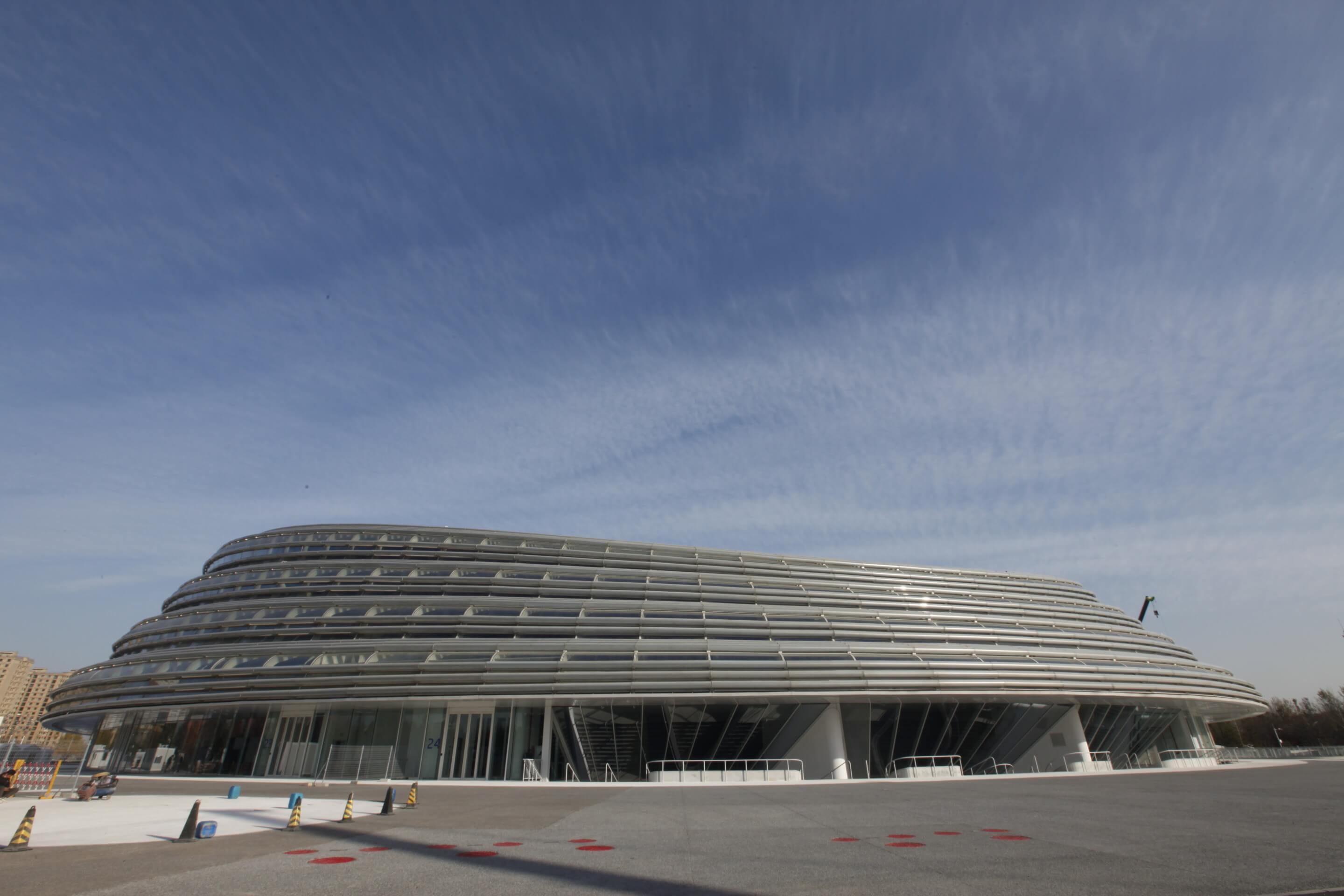 exterior of a discoid-shaped arena with blue skies