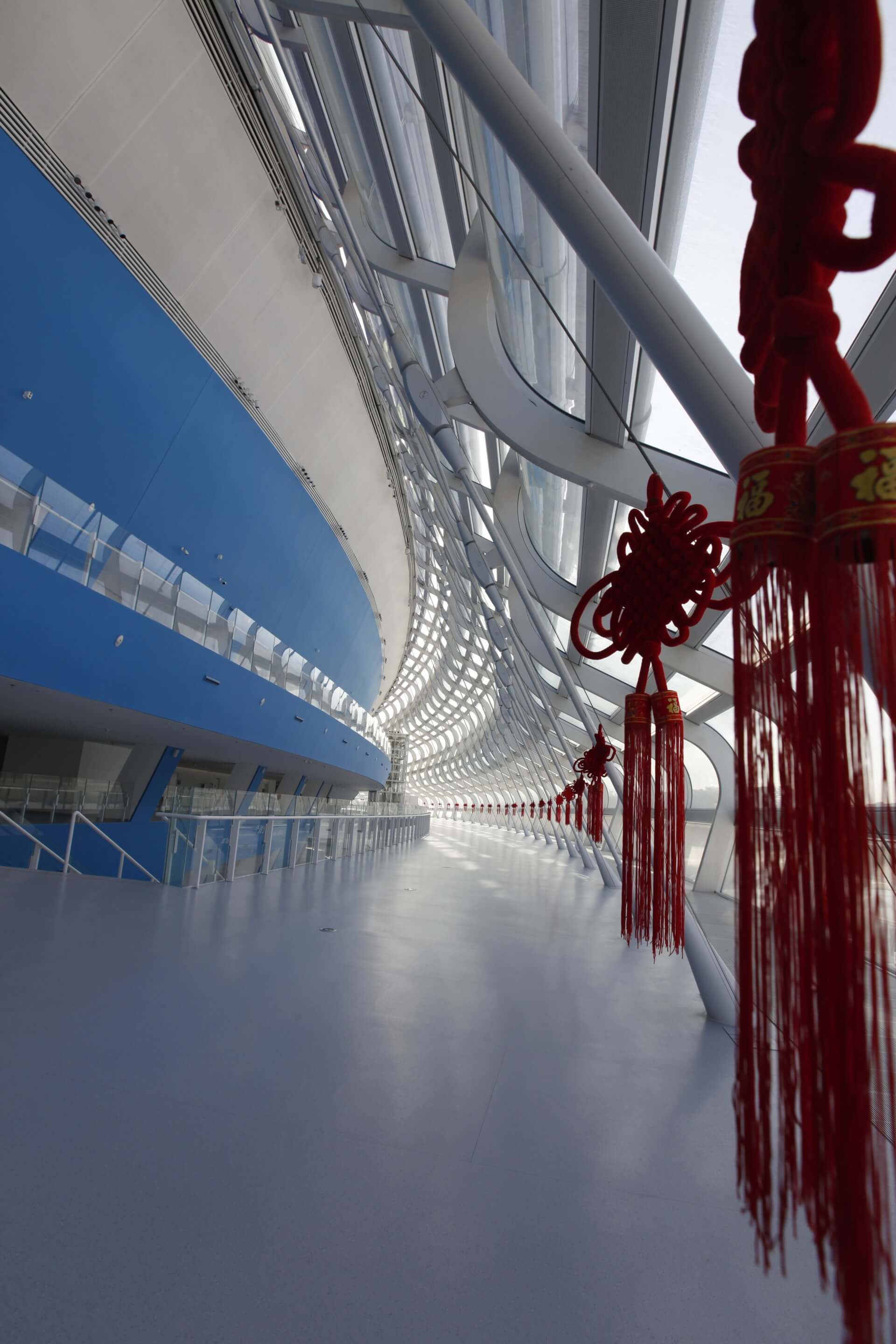 concourse of an ice sports arena with hanging chinese decor elements