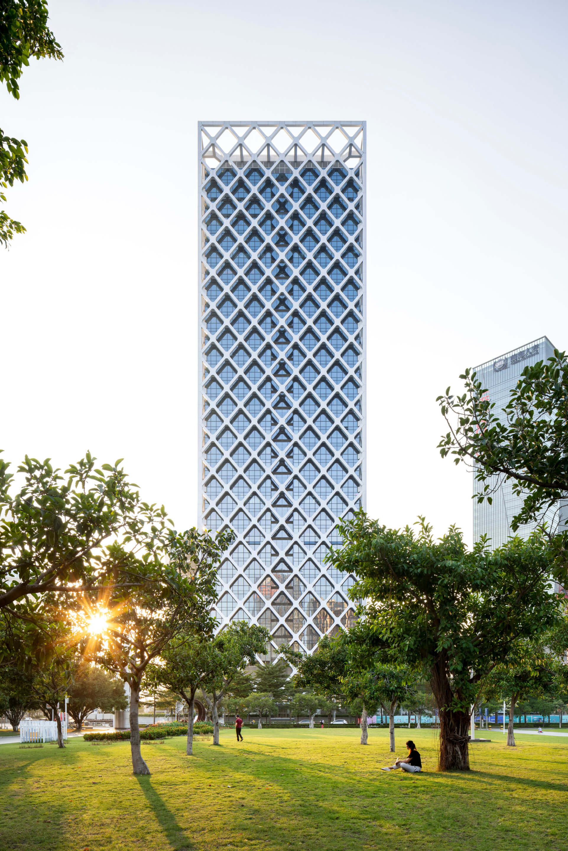 A glass tower wrapped in a diamond superstructure
