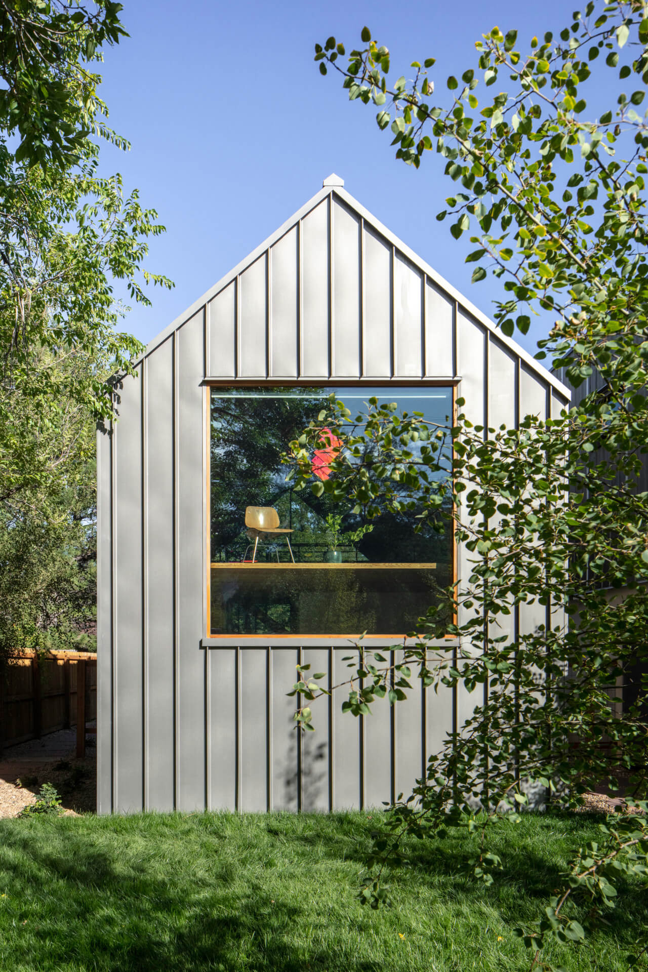 A gabled home covered by metal paneling
