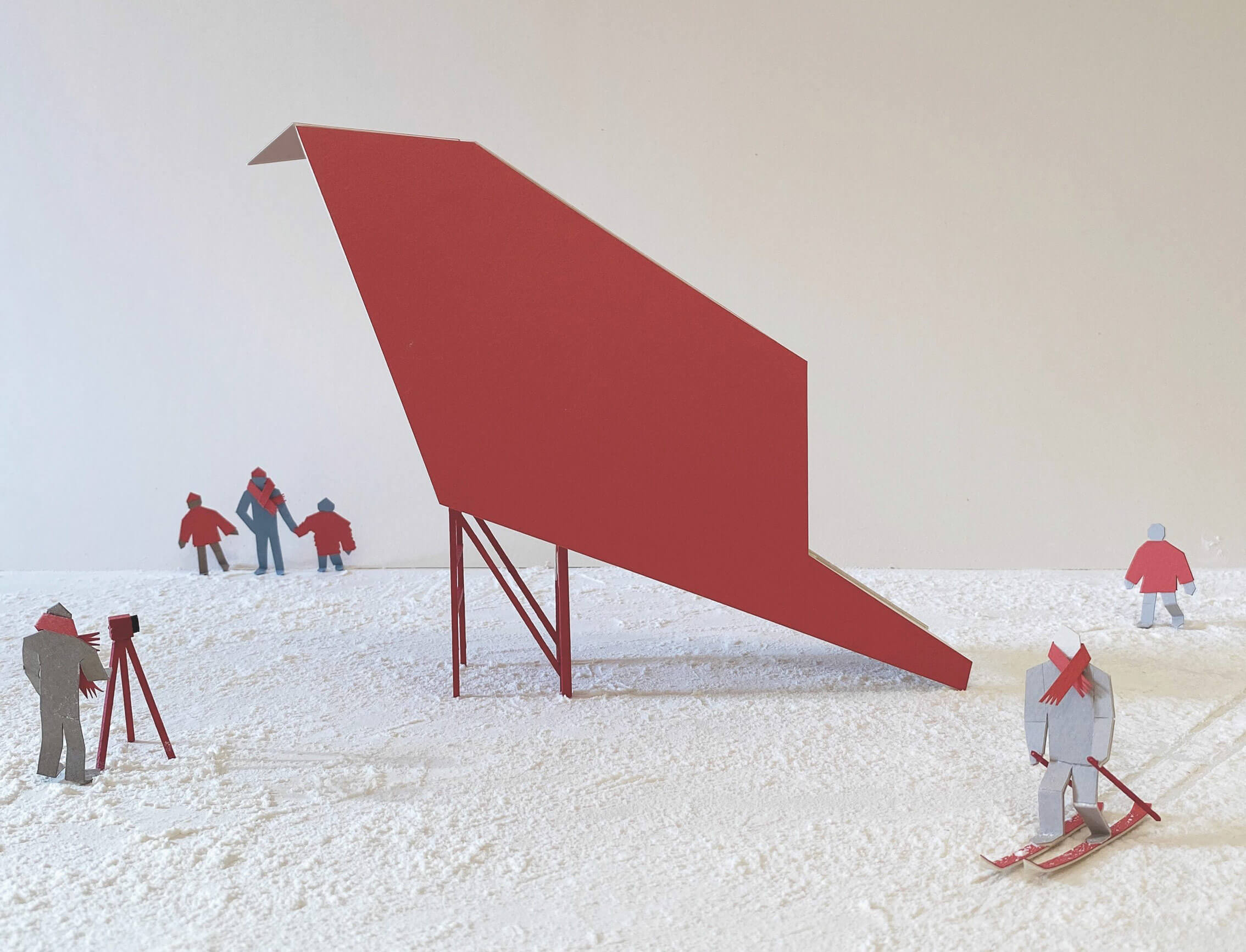 an angular red structure on a snowy beach