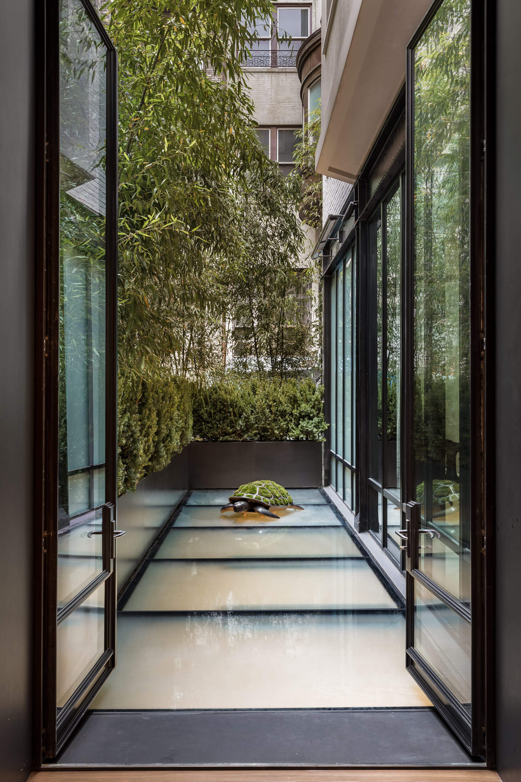 a New York City balcony with a glowing, opaque glass floor