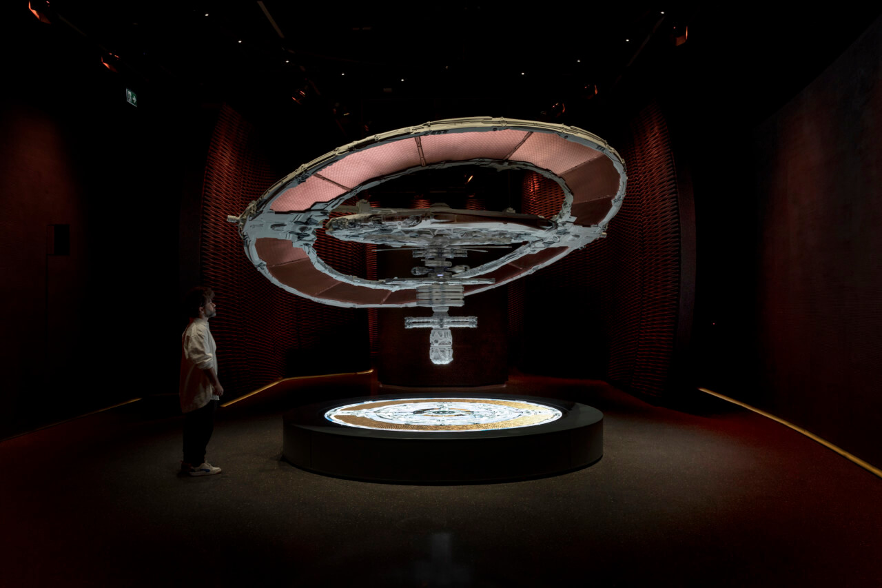 a museum exhibit with a floating spacecraft