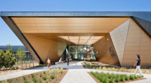 geometric entry to a building clad in gold panels