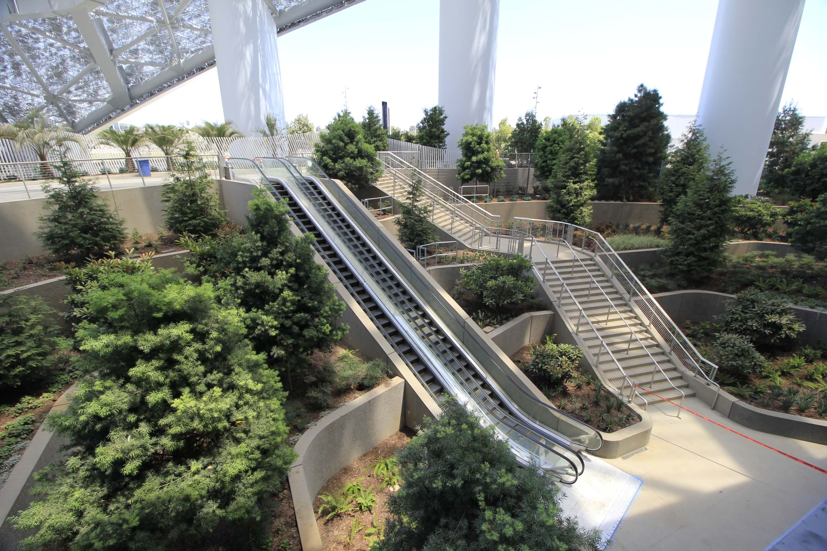 a terraced covered landscape with escalators