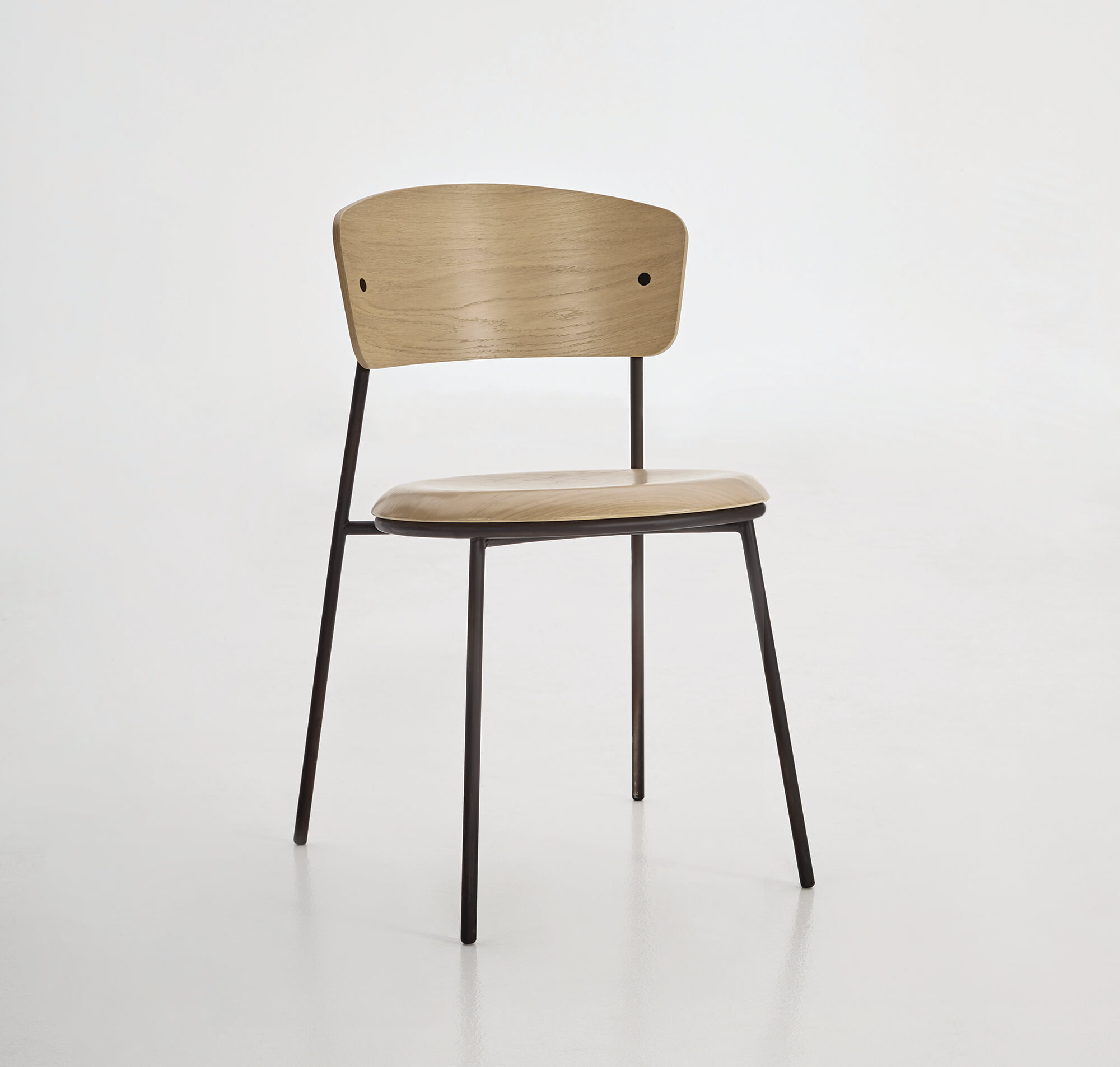 a light-colored wooden chair with rounded edges