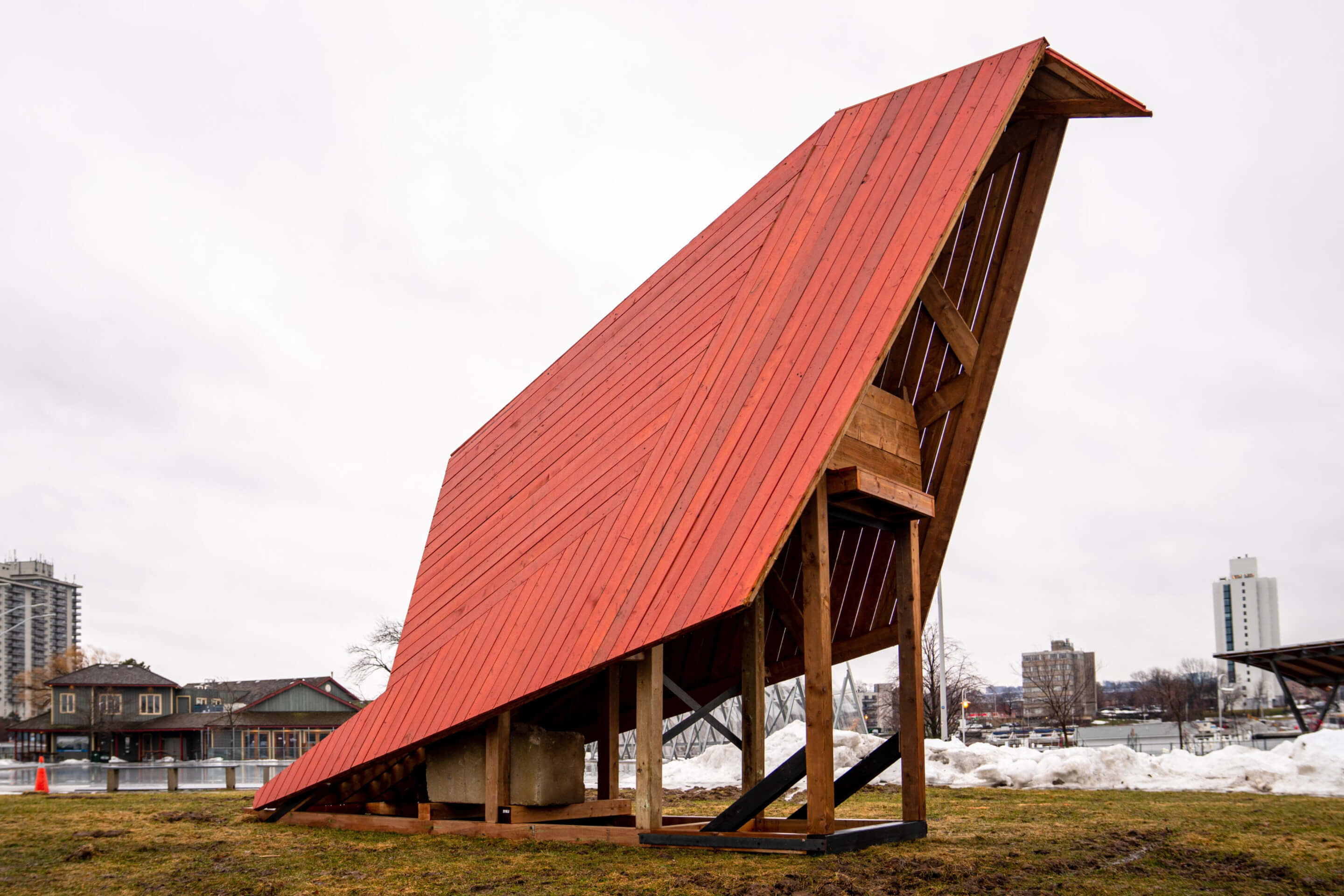 a beachfront pavilion with a large red roof 