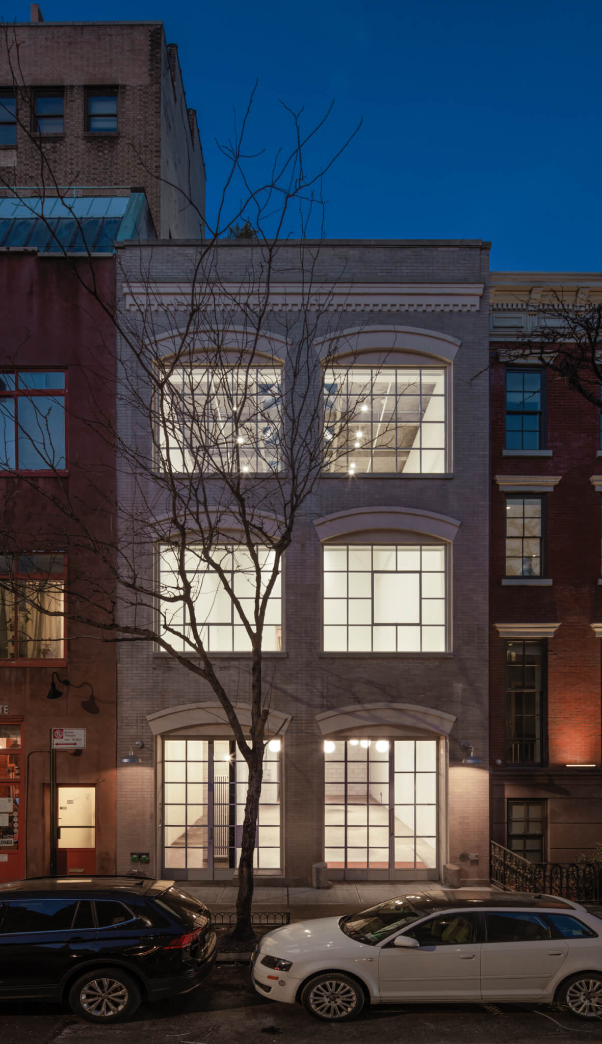 a historic new york building with windows illuminated at night