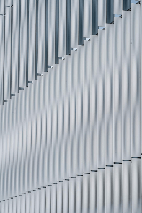 looking at a wave of vertical metal bands on a facade