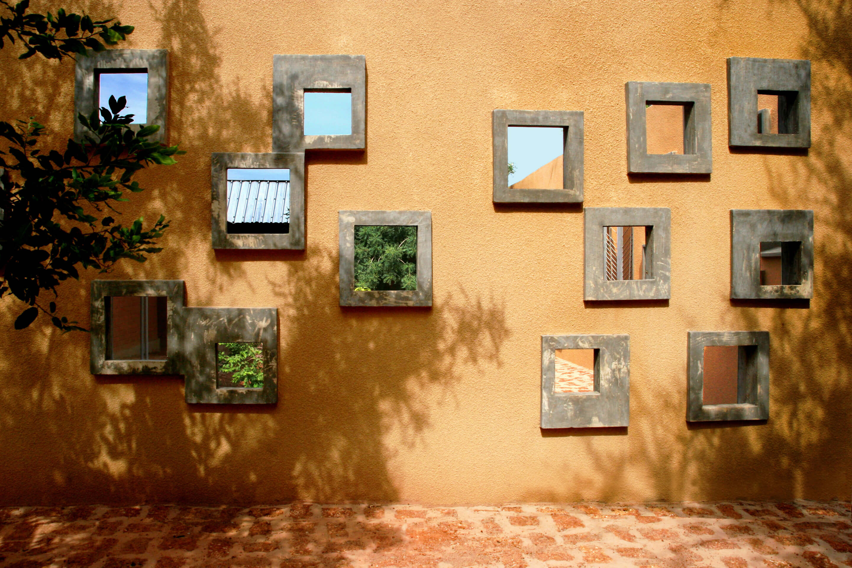 small windows on a clay mud wall
