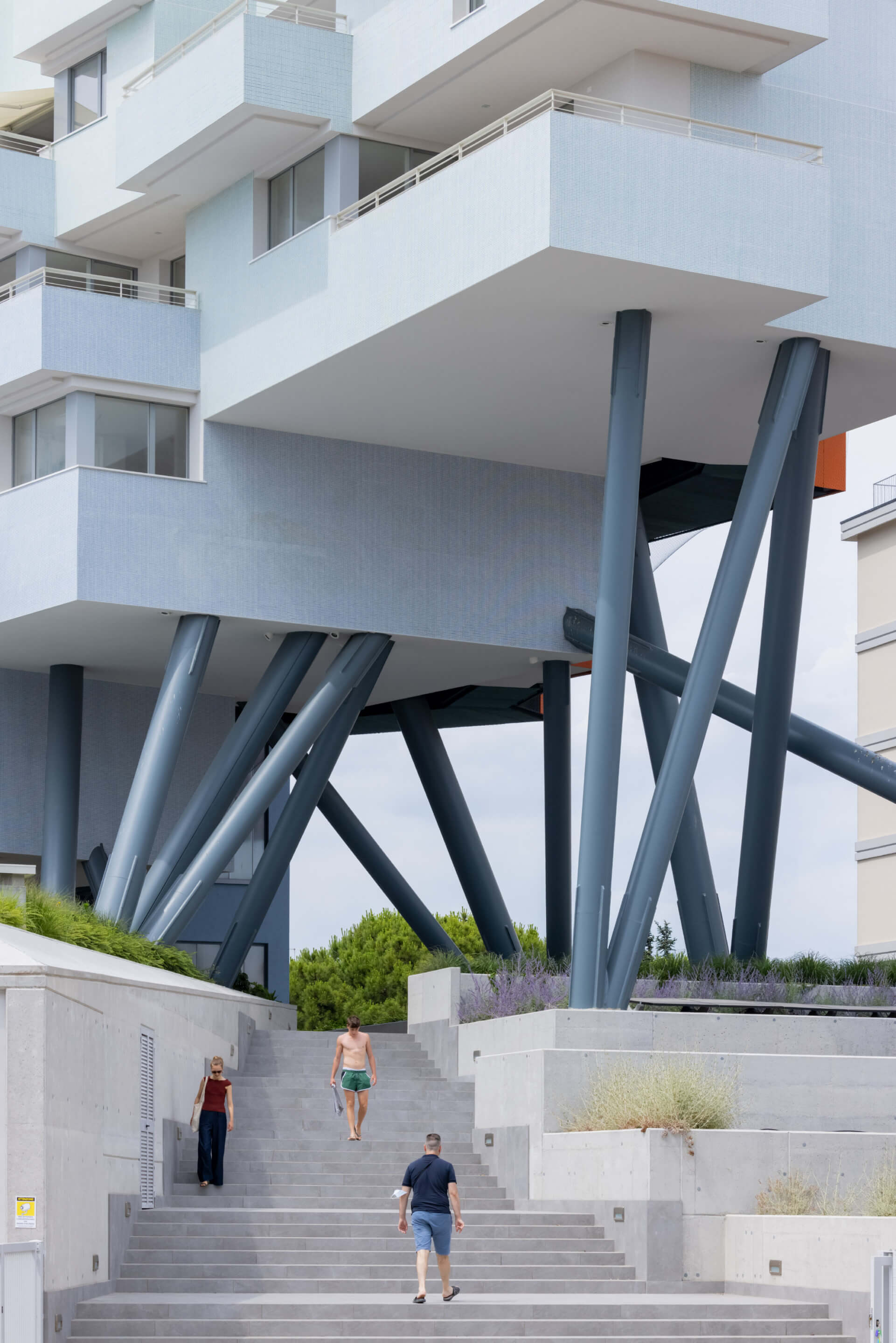 a boxy building on stilts in italy