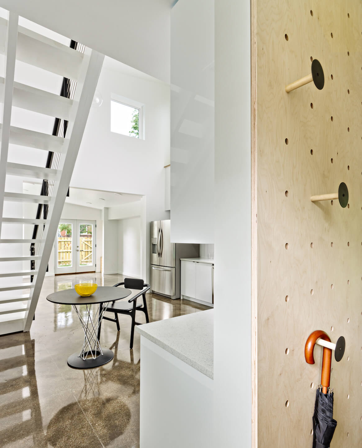view of an open kitchen space with pegboard storage