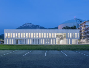 The long, boxy Neutron Research Centre against the mountains of the alps