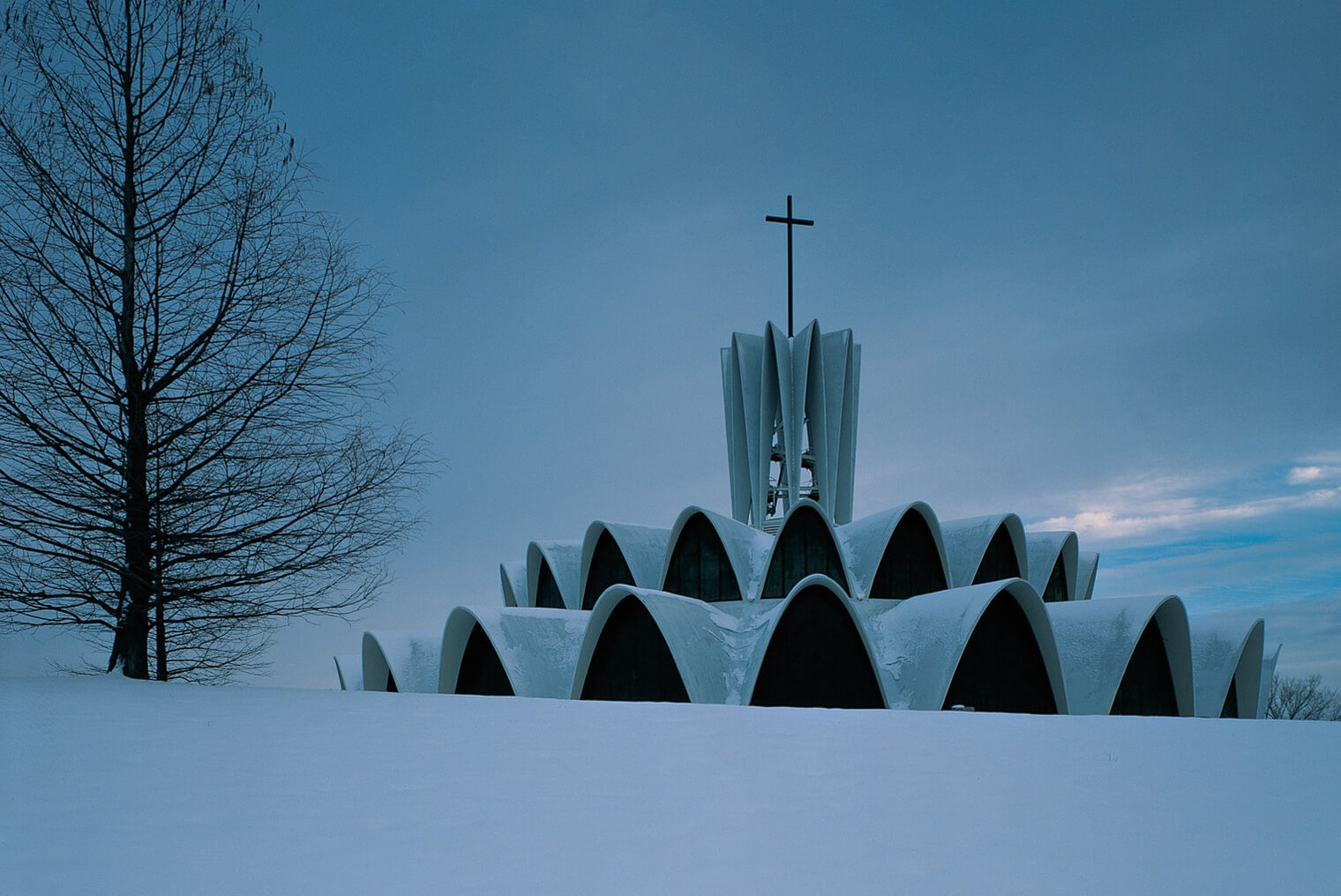 a chapel building with distinctive arches covered in snow
