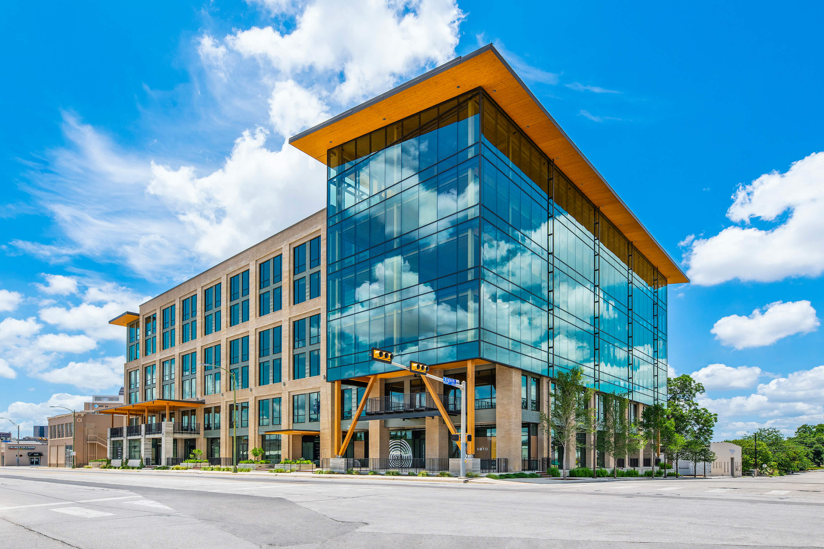 a large mixed-use building with mass timber elements and lots of glazing