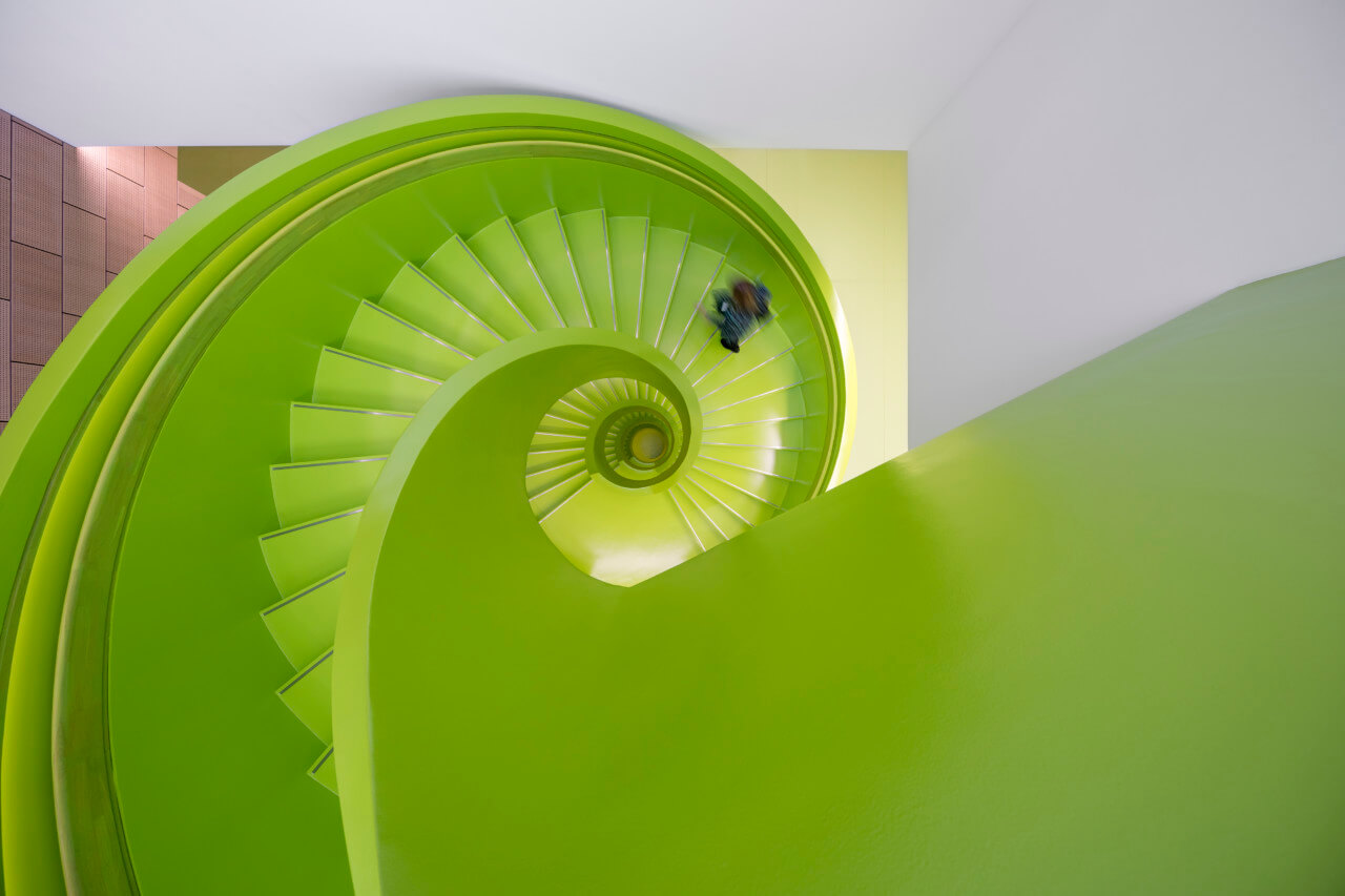 looking down through a green spiral staircase