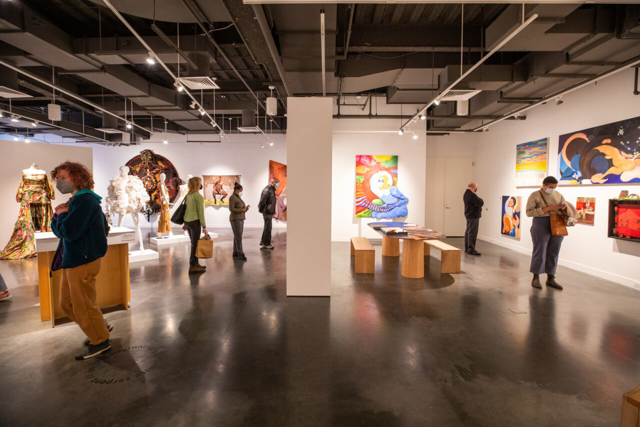 Open exhibition space with sculptures and paintings