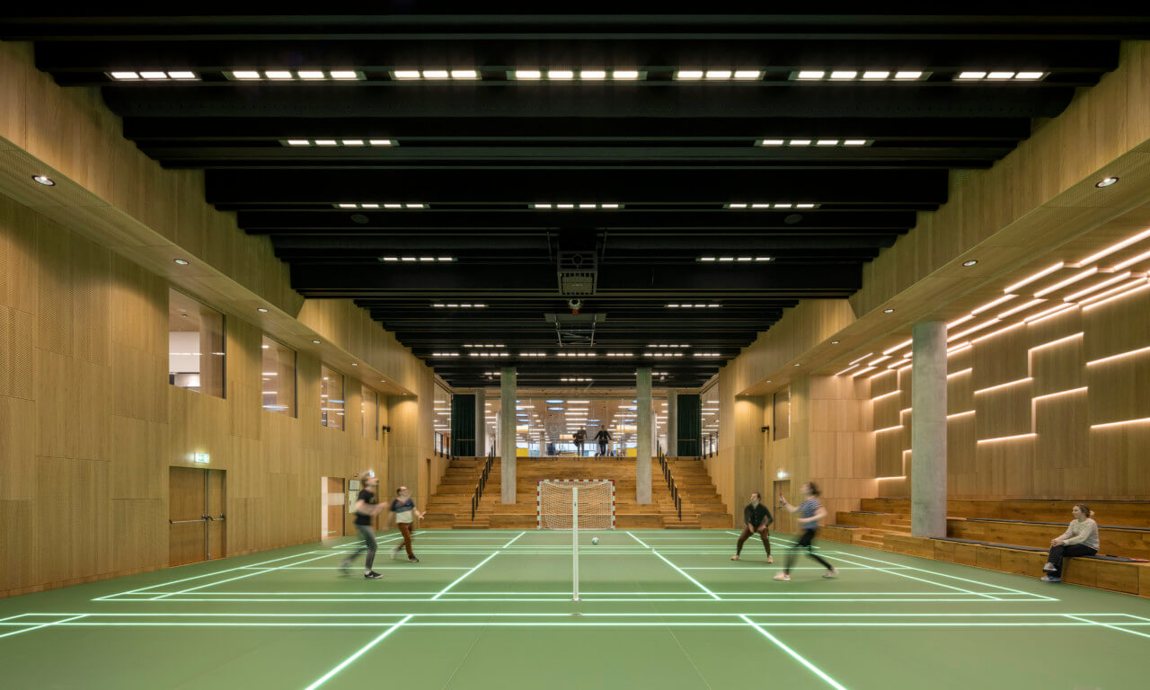 people playing sports in a large indoor court