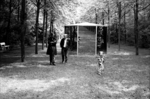B&W photo of two men and a child at a pavilion