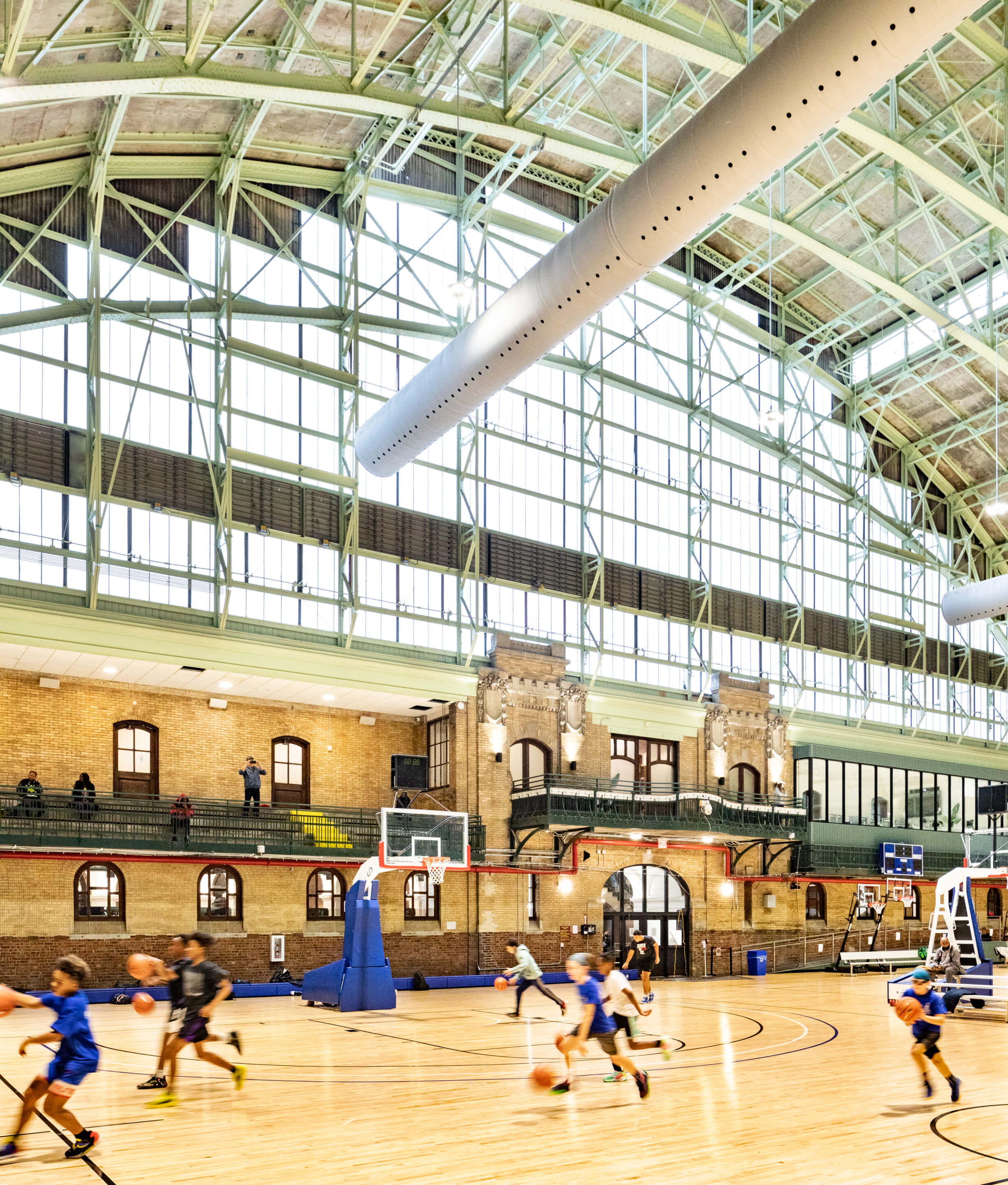 an indoor basketball court in a soaring historic spacae