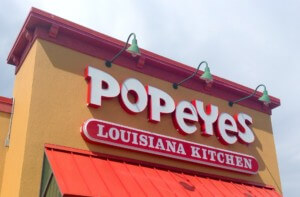 looking up at a Popeyes storefront