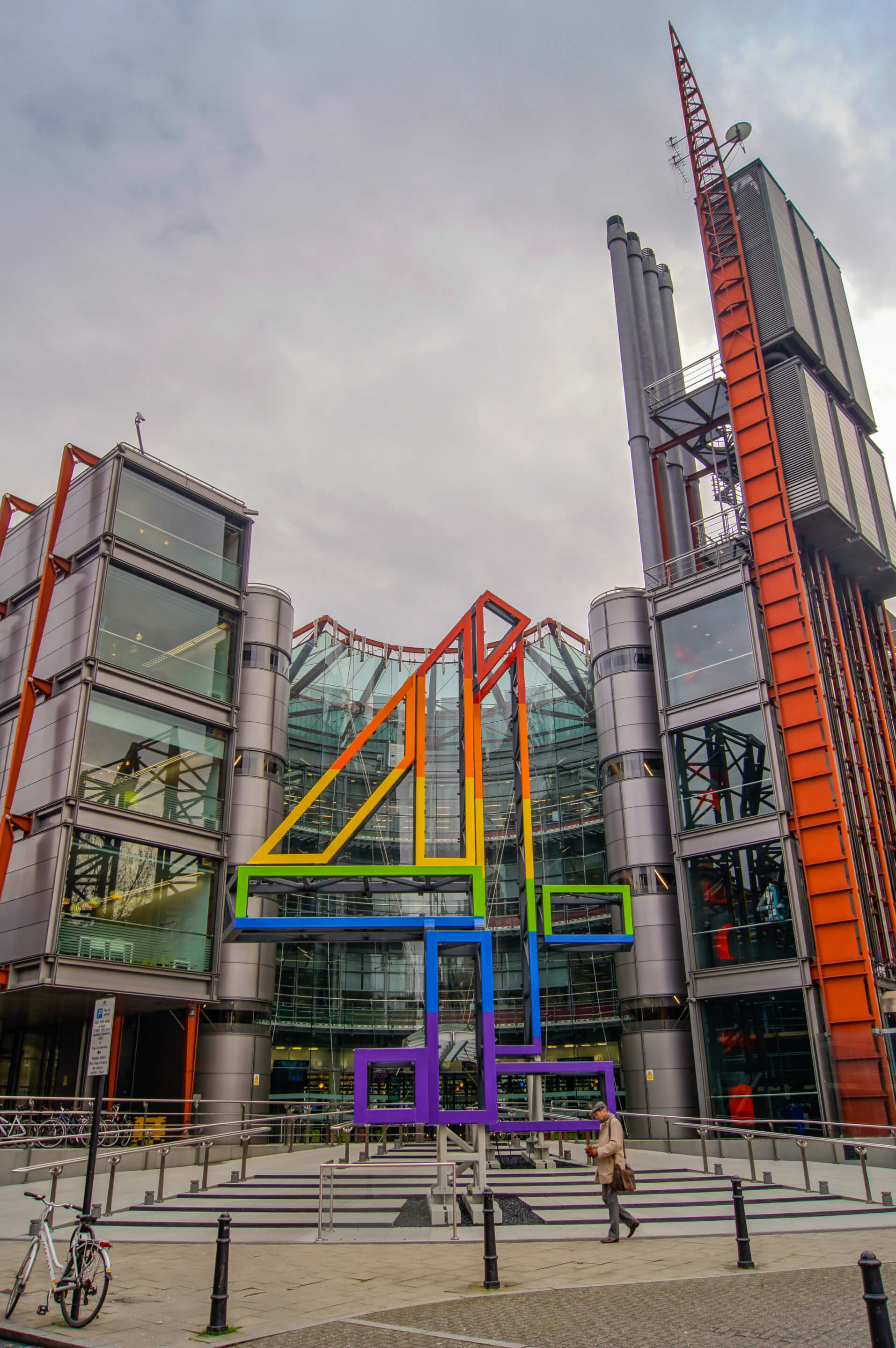 exterior of a broadcasting building in london with a giant rainbow "4"