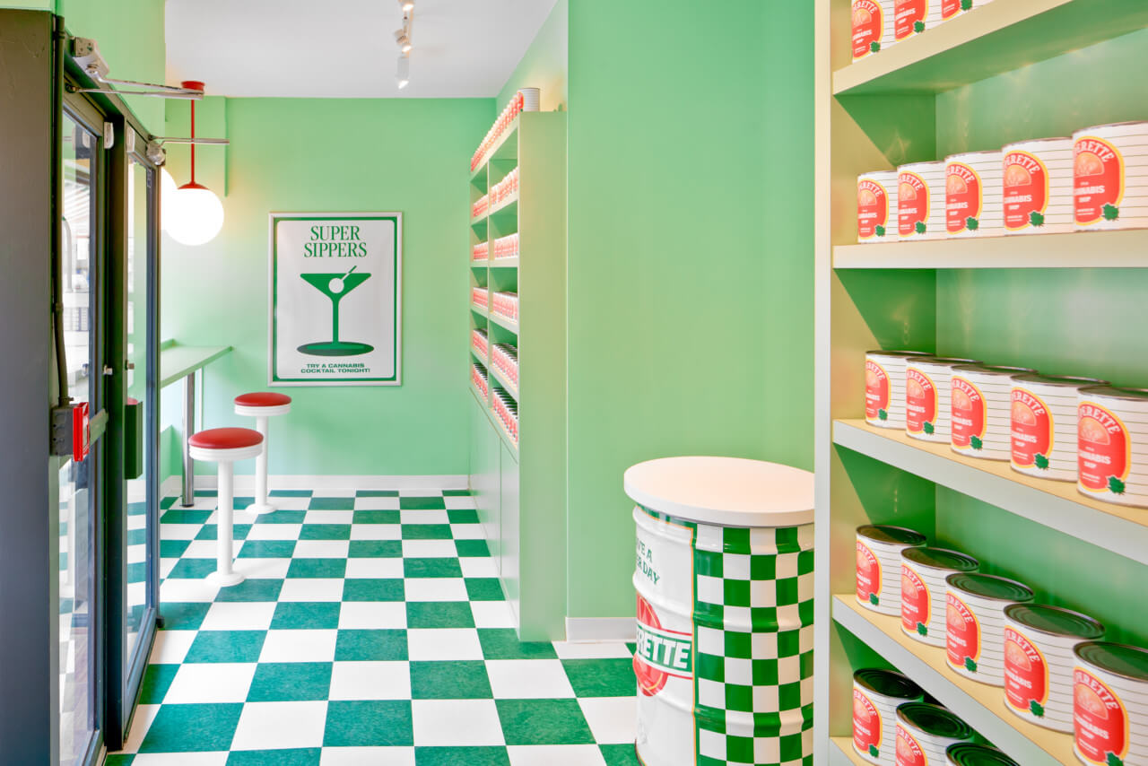 a deli-inspired weed dispensary with checkered flooring and product cases