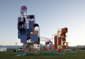 a colorful vertical architectural installation rising from the desert