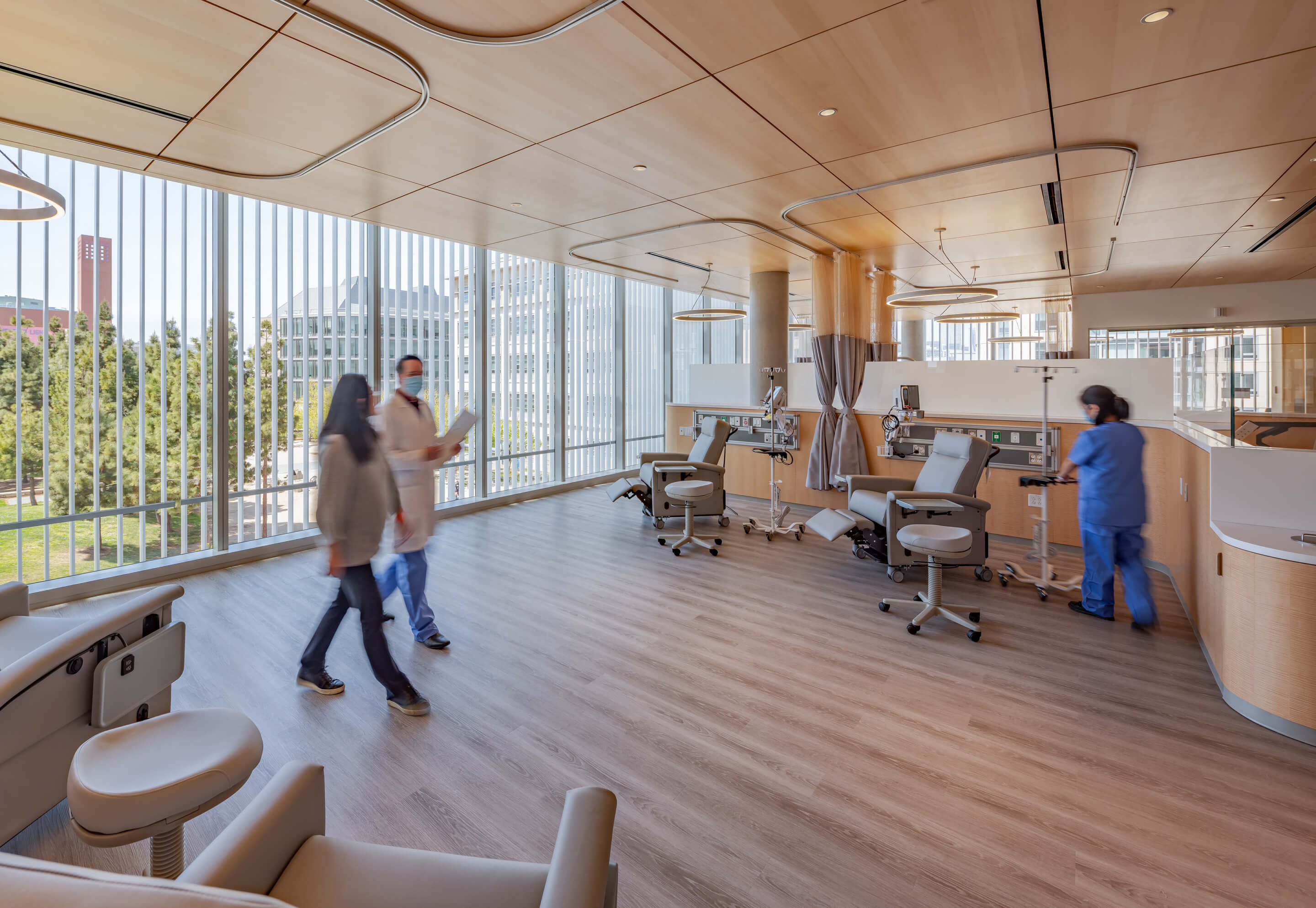 people walk through a light-filled medical space