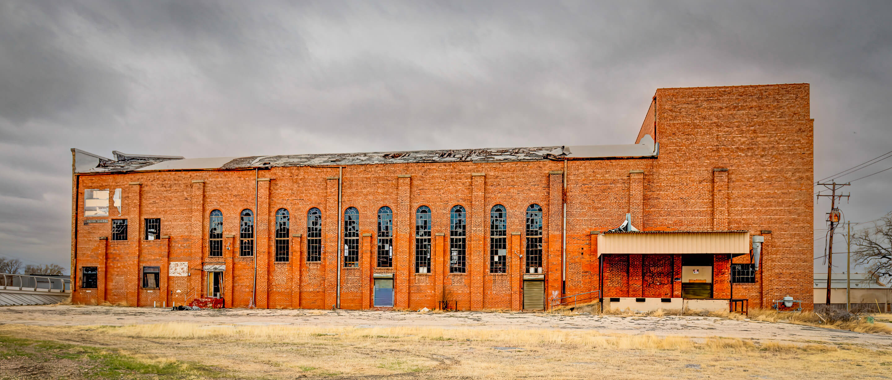 exterior view of a decaying brick warehouse building 