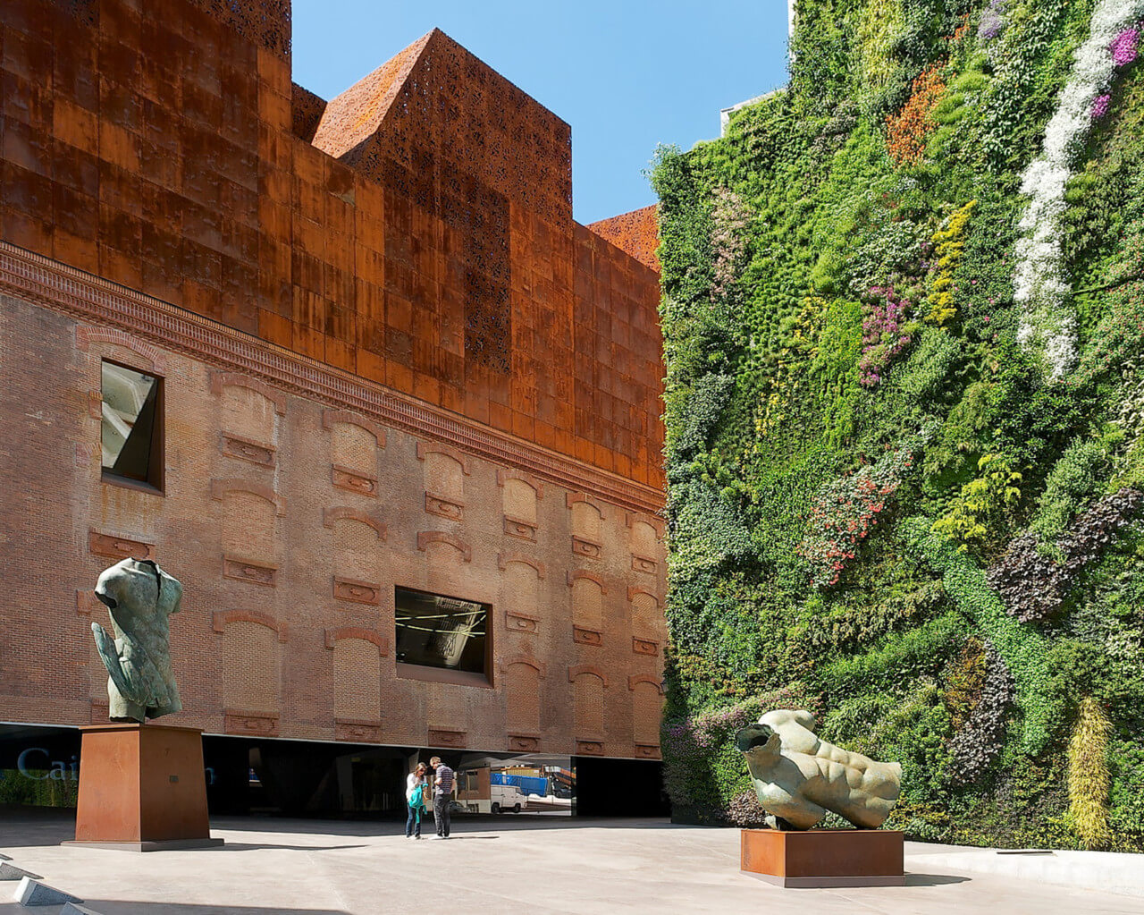 a historic building in madrid with a large living wall