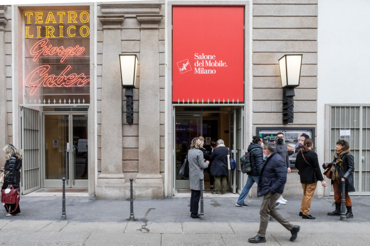 crowds gather outside a banner for Salone del Mobile