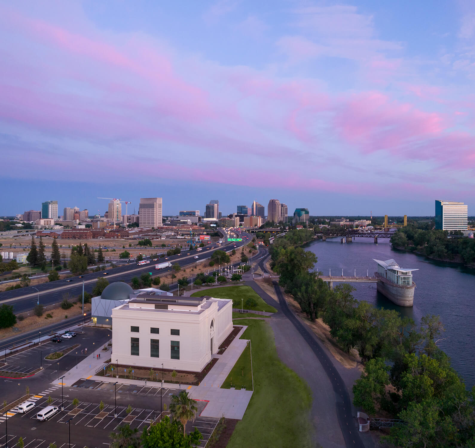 aerial view of a riverfront science center at sunrise