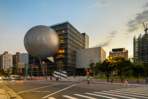 a theater complex with a globe-shaped volume extending from a boxy building