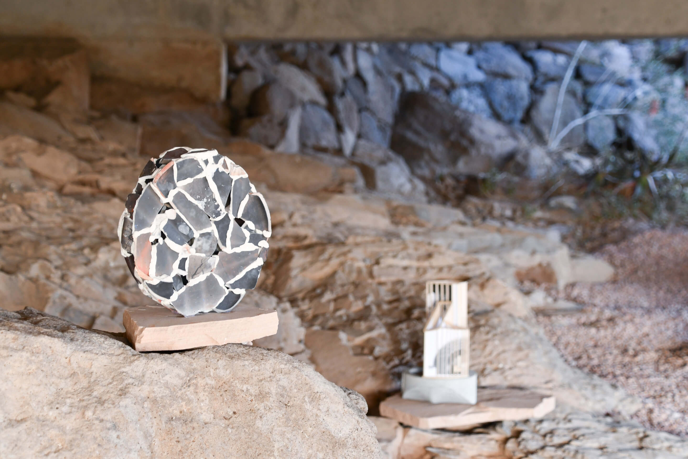 art objects instsalled in a rocky landscape