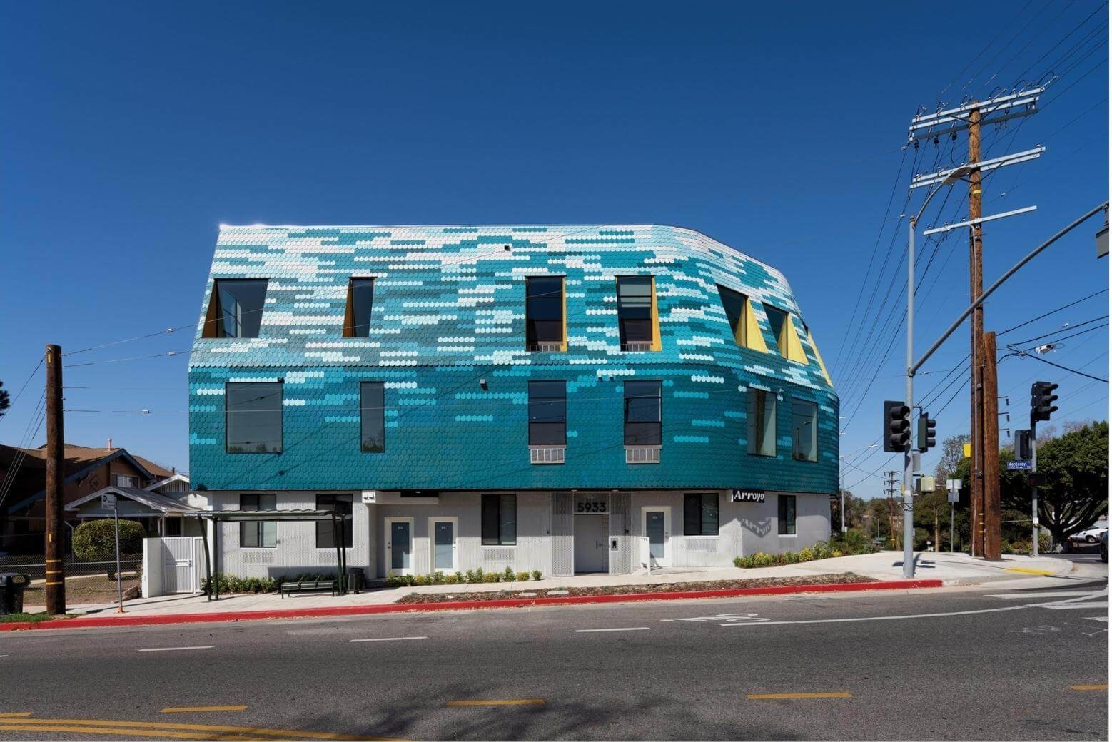 exterior of a small multi-family building with a colorful textured facade
