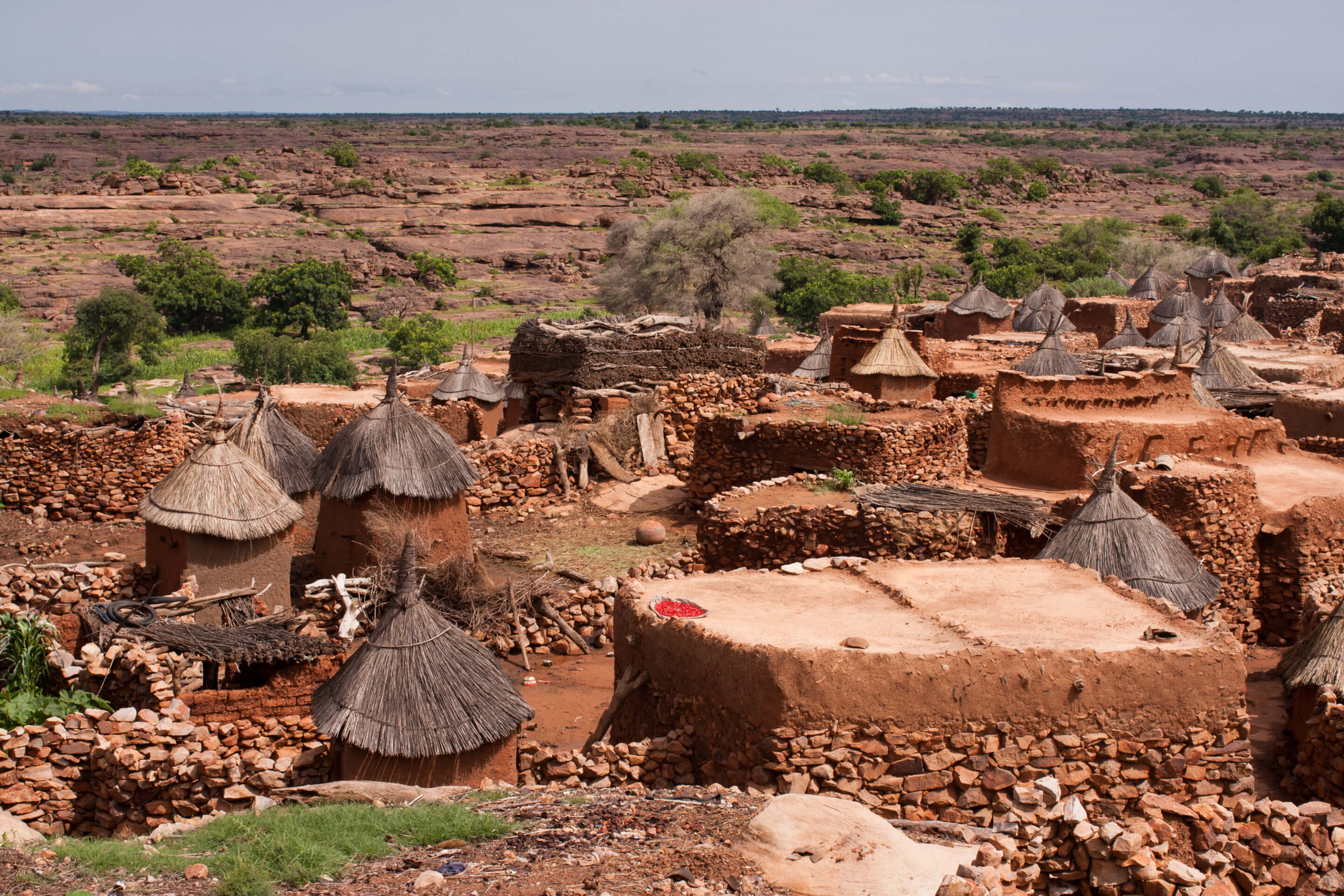 an african village of circular homes with thatched roofs