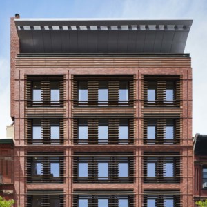 front view of terra-cotta brick building with windoes