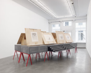 architectural drawings on display in a gallery space