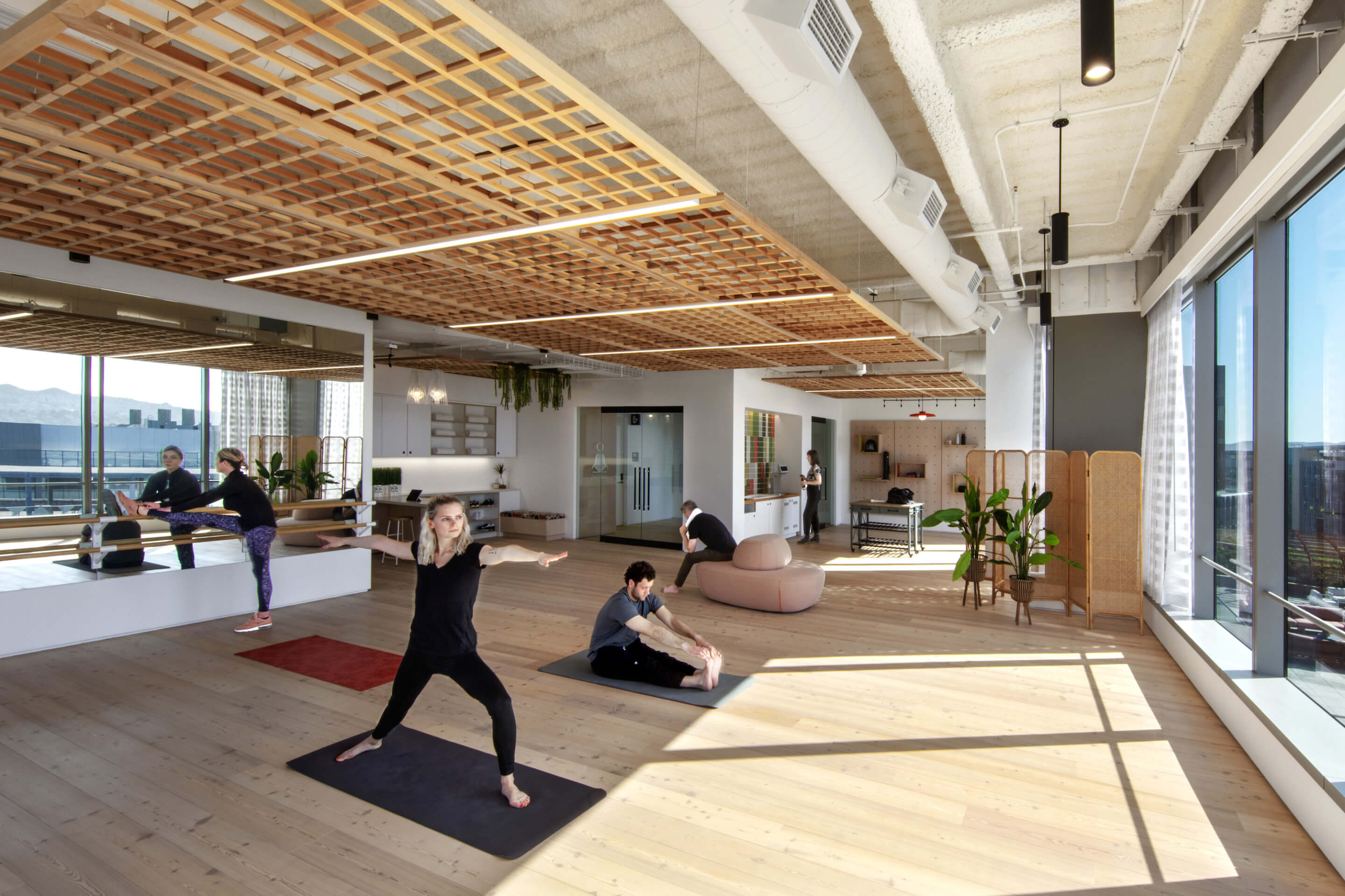 people practice yoga in an airy studio space