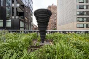 spinning tornado sculpture surrounded by grass