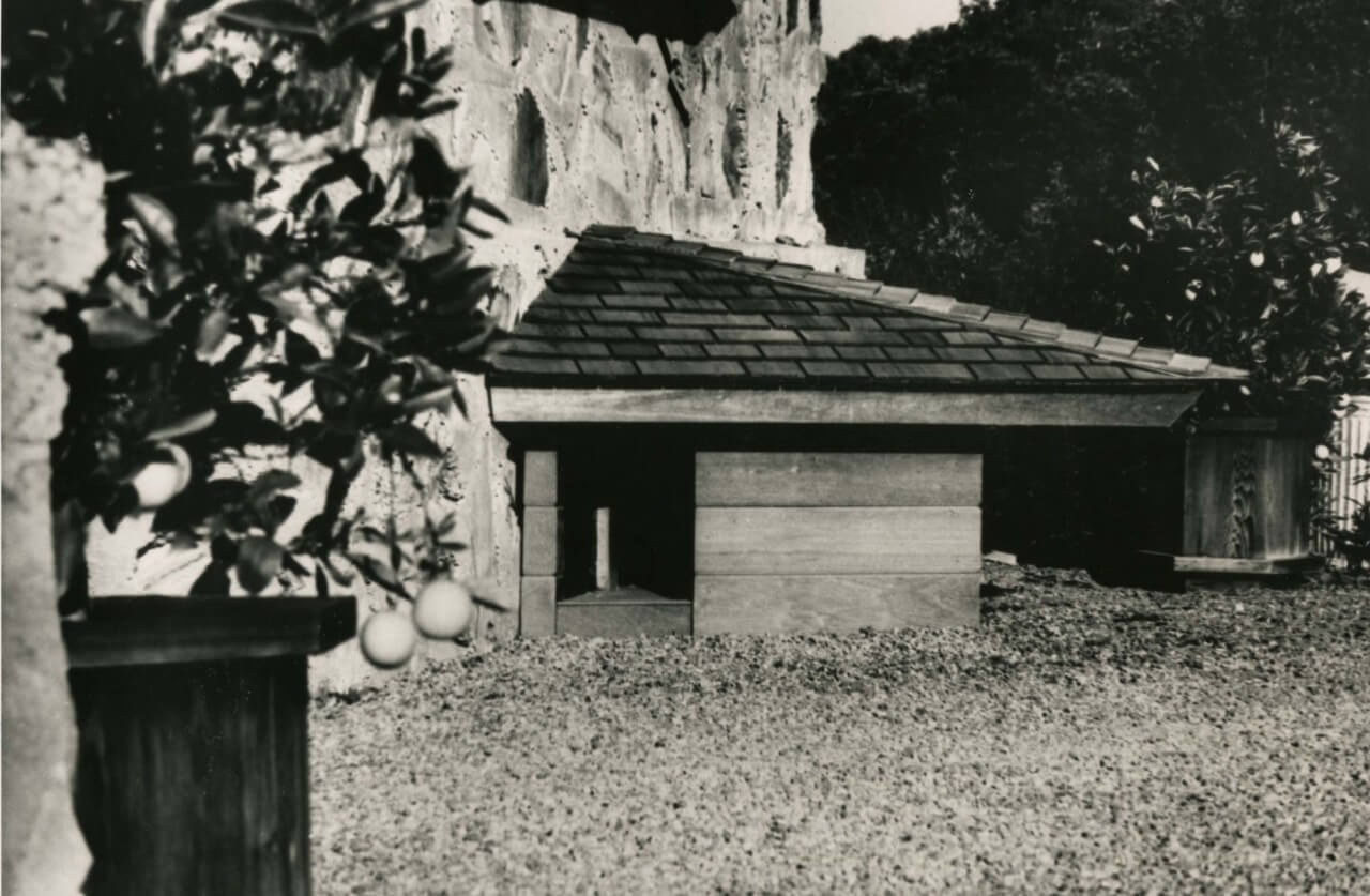 black and white image of doghouse with angular roof