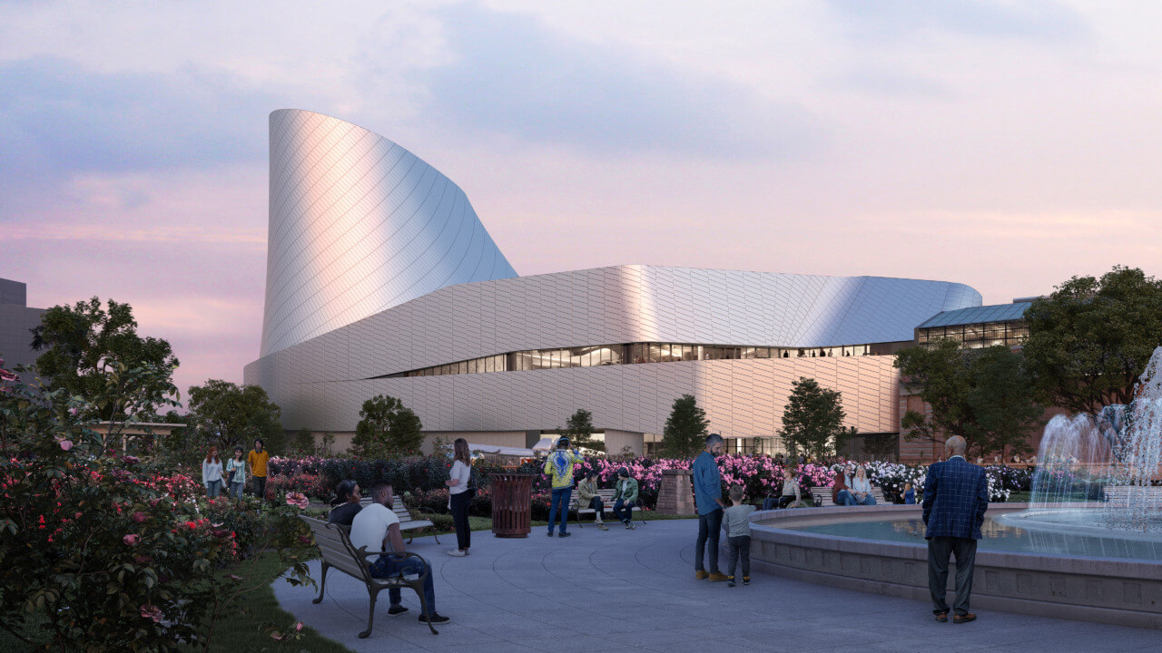 rendering of a sleek, silver science museum building as seen from a rose garden at dusk