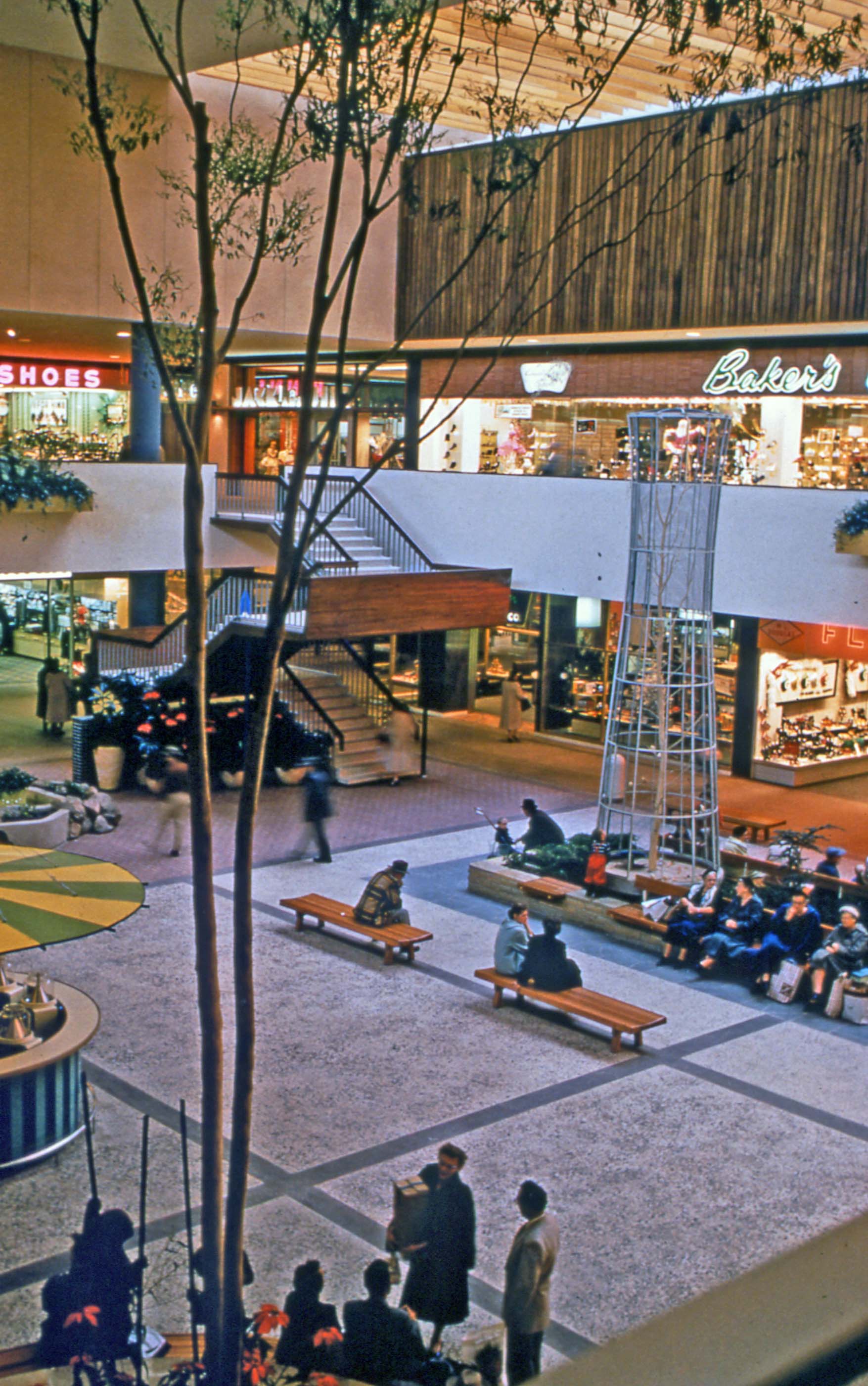 archival photo of a shopping mall with two levels and an escalator