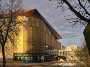 exterior of a gold panel clad academic building