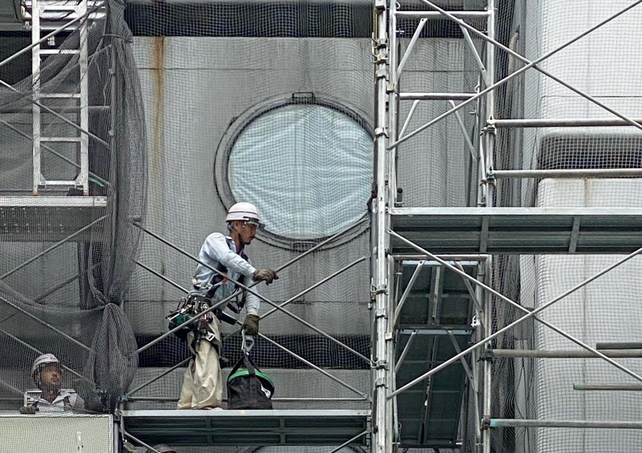a worker and scaffolding on a demolition project