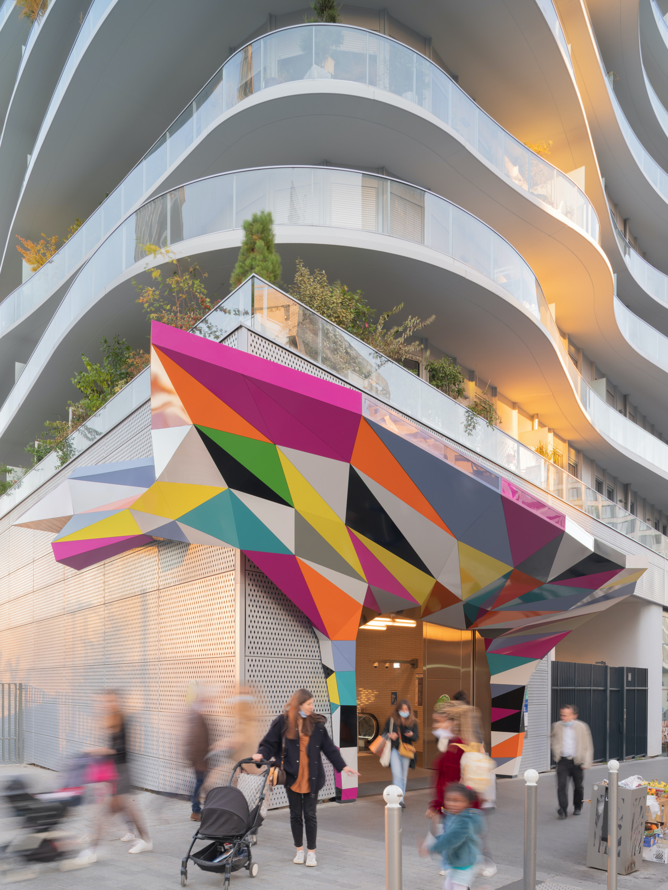 a colorful sculptural installation topping a metro entrance in paris