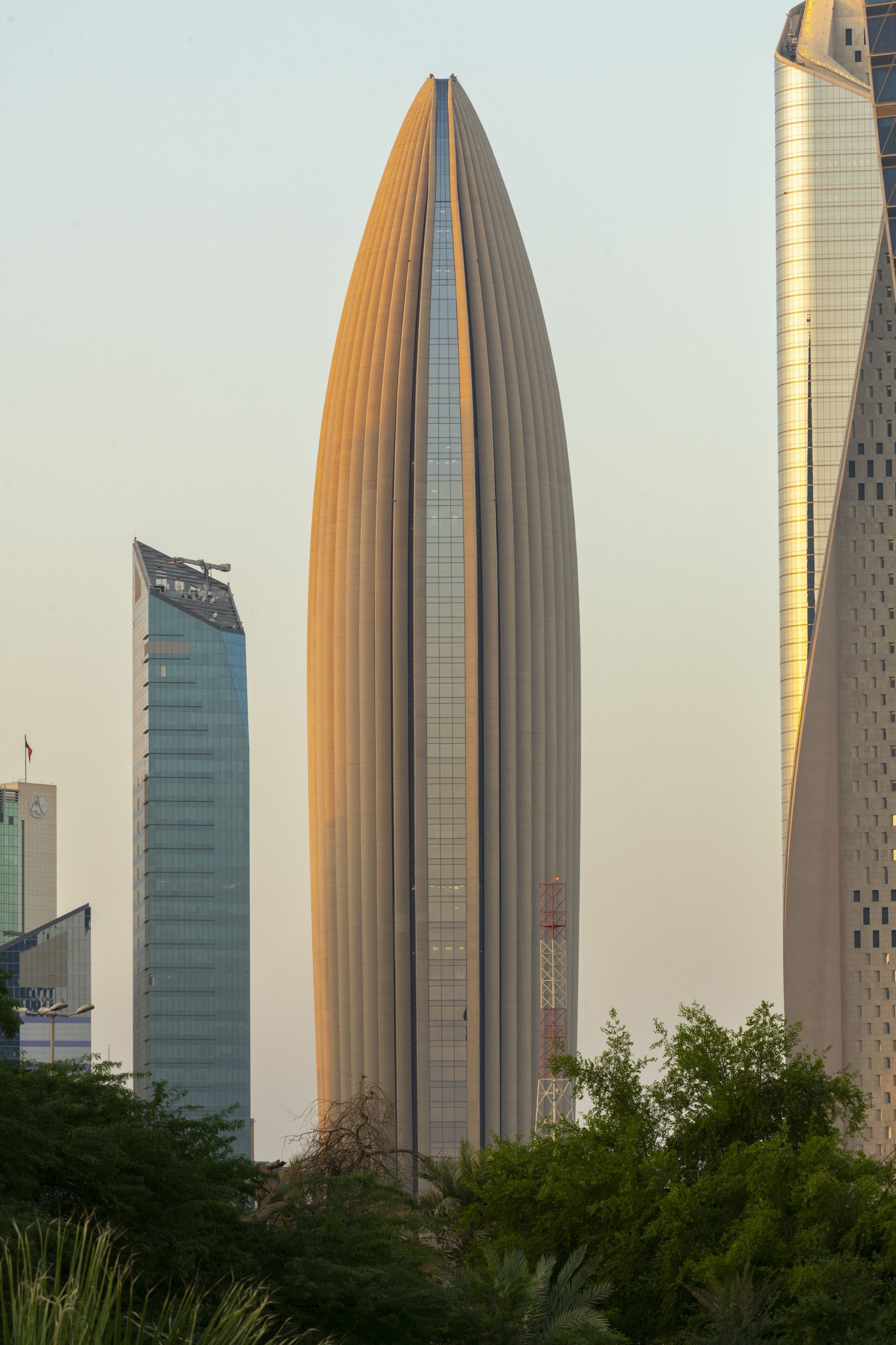 view of a rounded skyscraper clad in concrete fins