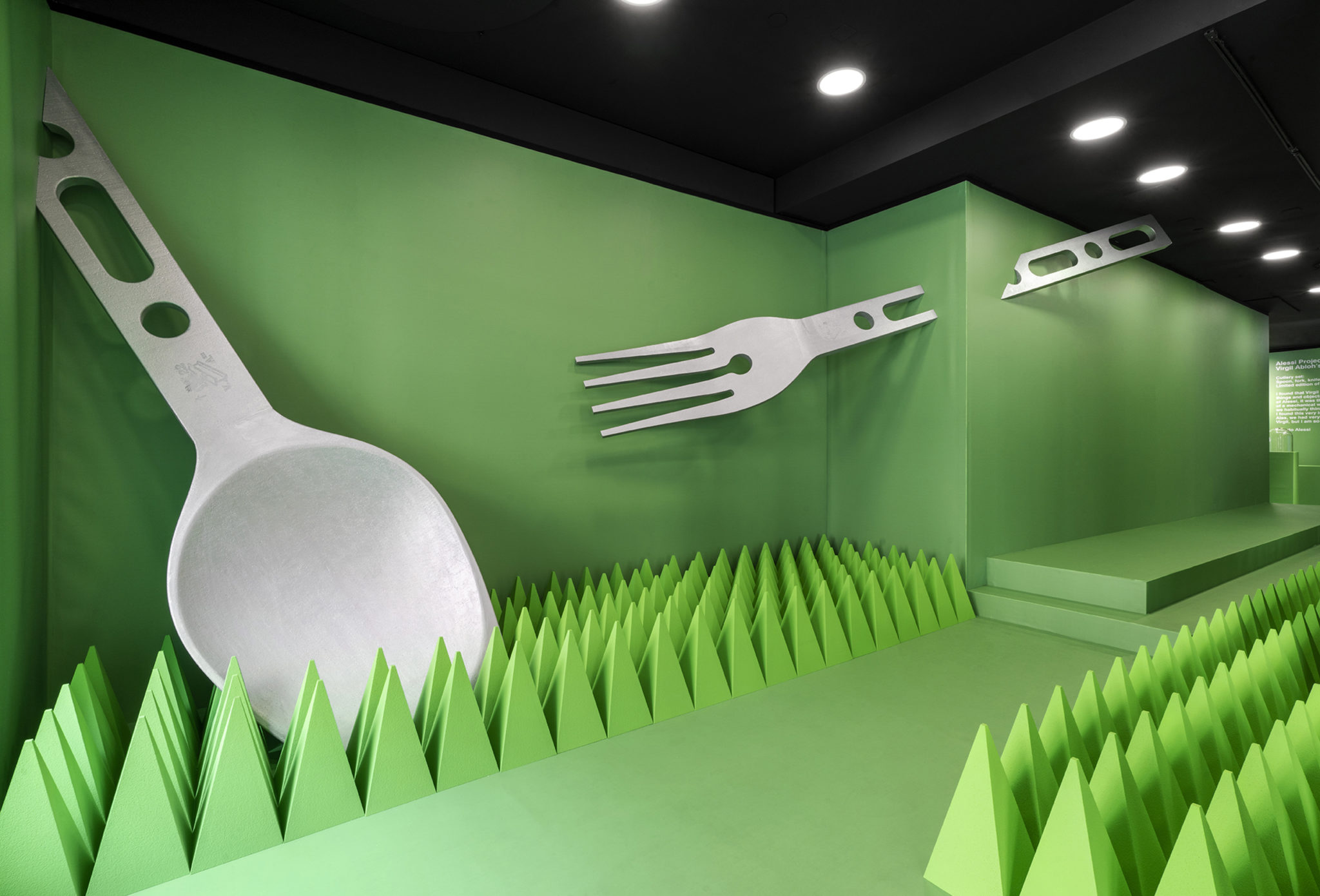 massive fork and spoon on green wall